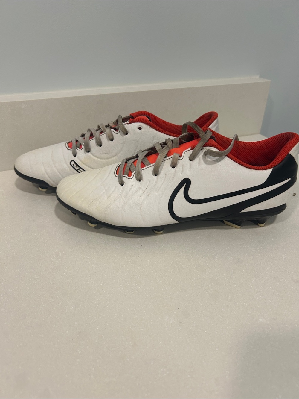 Nike Men’s White Soccer Cleats with Black Swoosh and Red Lining